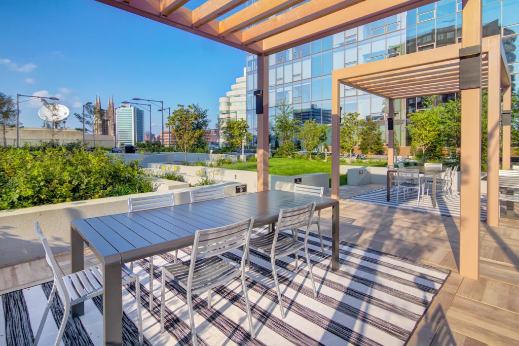 Outdoor sundeck with pergolas and tables.